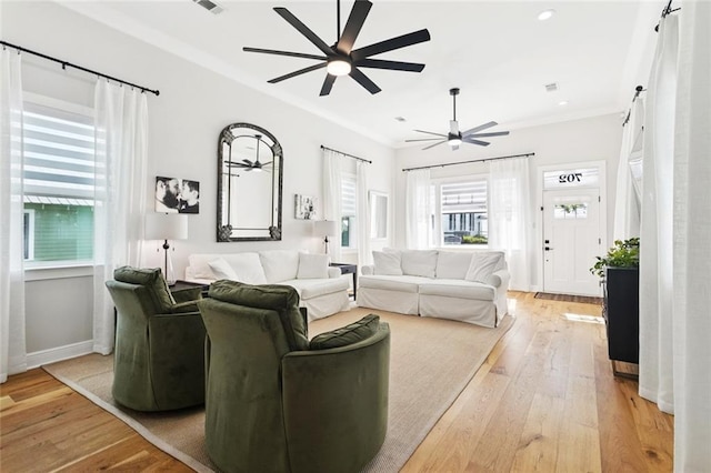 702 Pine St, Madisonville, LA 70447 - living area featuring a ceiling fan, light wood finished floors, ornamental molding, and recessed lighting