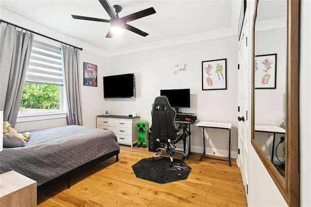 702 Pine St, Madisonville, LA 70447 - bedroom with light wood-style floors, a desk, ornamental molding, and a ceiling fan
