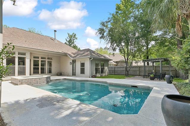230 Delta Dr, Mandeville, LA 70448 - view of pool with a patio area, a fenced backyard, a pergola, and a pool with connected hot tub