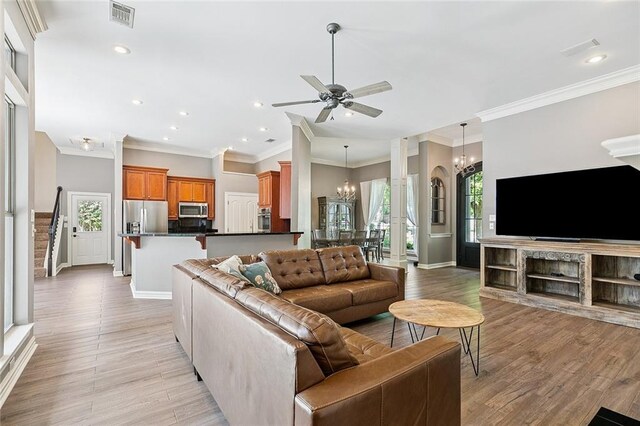 230 Delta Dr, Mandeville, LA 70448 - living room featuring a chandelier, crown molding, plenty of natural light, recessed lighting, and light wood finished floors