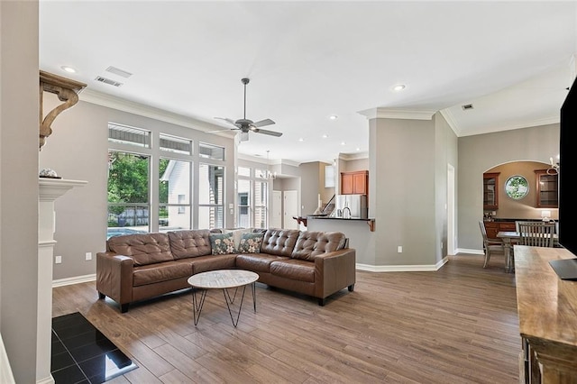 230 Delta Dr, Mandeville, LA 70448 - living area with ornamental molding, arched walkways, a ceiling fan, wood finished floors, and recessed lighting