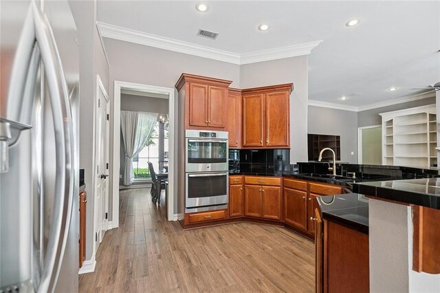 230 Delta Dr, Mandeville, LA 70448 - bedroom featuring a raised ceiling, wood finished floors, ornamental molding, and ceiling fan