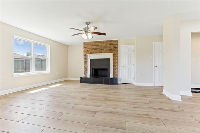3028 Concordia Dr, La Place, LA 70068 - unfurnished living room with ceiling fan, light wood-style floors, and a tiled fireplace