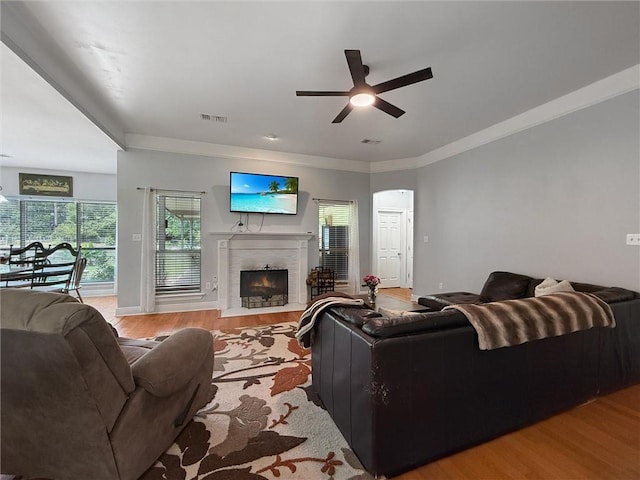 201 Stephanie Ln, Covington, LA 70435 - living room featuring wood finished floors, ceiling fan, a tile fireplace, and crown molding