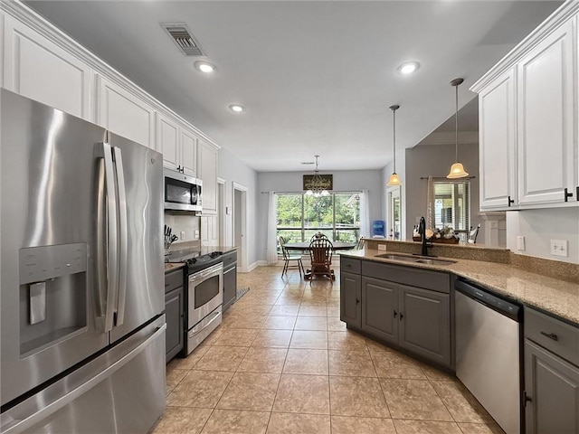 201 Stephanie Ln, Covington, LA 70435 - kitchen featuring appliances with stainless steel finishes, gray cabinetry, white cabinets, recessed lighting, and a chandelier