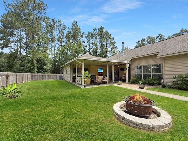 201 Stephanie Ln, Covington, LA 70435 - rear view of house with an outdoor fire pit, a patio, a fenced backyard, and a shingled roof