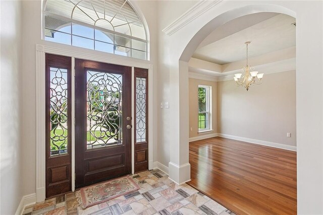 178 Colony Rd, Belle Chasse, LA 70037 - foyer with a chandelier, arched walkways, and light wood finished floors