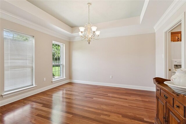 178 Colony Rd, Belle Chasse, LA 70037 - empty room with wood finished floors, a chandelier, a raised ceiling, and ornamental molding