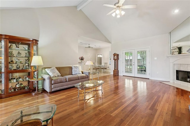 178 Colony Rd, Belle Chasse, LA 70037 - living room with a ceiling fan, high vaulted ceiling, beamed ceiling, wood finished floors, and a tile fireplace
