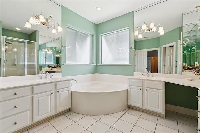 178 Colony Rd, Belle Chasse, LA 70037 - full bathroom featuring a chandelier, a shower stall, two vanities, a bath, and tile patterned floors