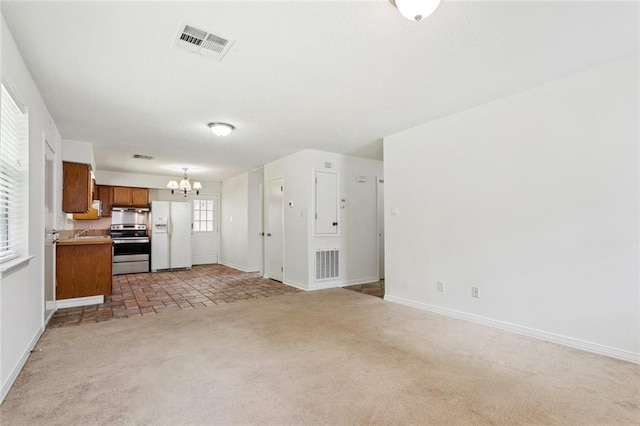 205 Timber Ridge Dr, Slidell, LA 70460 - unfurnished living room featuring a chandelier and light carpet