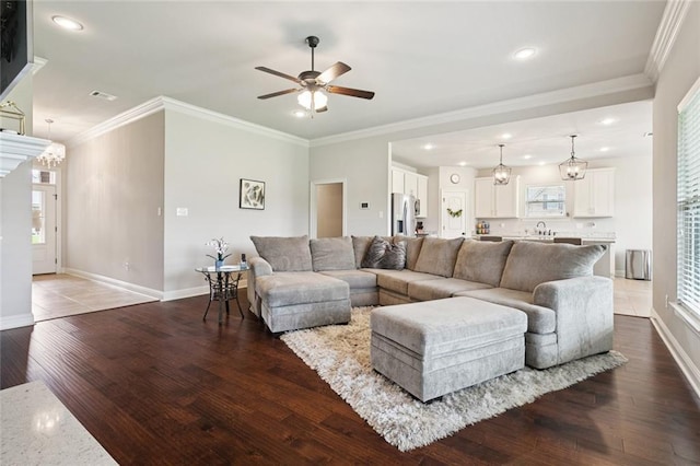 42030 Wood Ave, Ponchatoula, LA 70454 - living area with ceiling fan, wood finished floors, recessed lighting, plenty of natural light, and crown molding