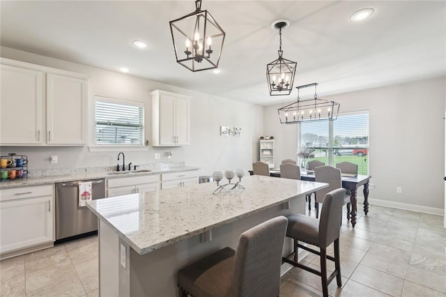 42030 Wood Ave, Ponchatoula, LA 70454 - kitchen featuring dishwasher, a chandelier, a breakfast bar, a kitchen island, and white cabinetry