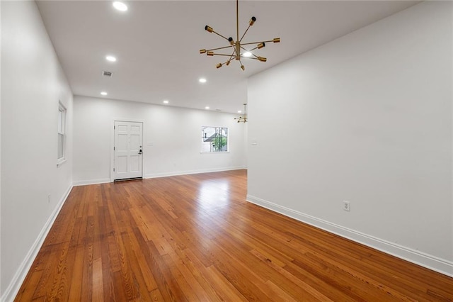 5624-5626 Annunciation St, New Orleans, LA 70115 - unfurnished room with a chandelier, wood finished floors, and recessed lighting