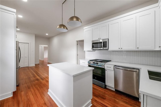 5624-5626 Annunciation St, New Orleans, LA 70115 - kitchen featuring stainless steel appliances, a kitchen island, decorative backsplash, light countertops, and white cabinets