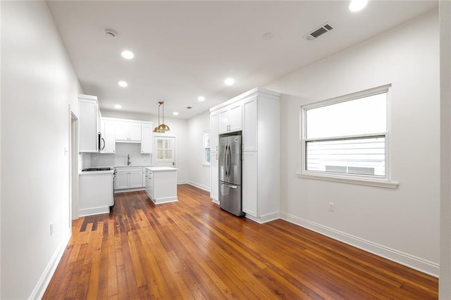 5624-5626 Annunciation St, New Orleans, LA 70115 - kitchen featuring freestanding refrigerator, dark wood finished floors, white cabinets, a center island, and recessed lighting