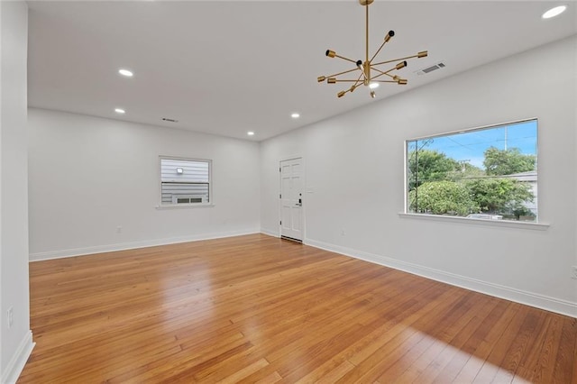 5624-5626 Annunciation St, New Orleans, LA 70115 - unfurnished room with light wood-style flooring, a chandelier, and recessed lighting