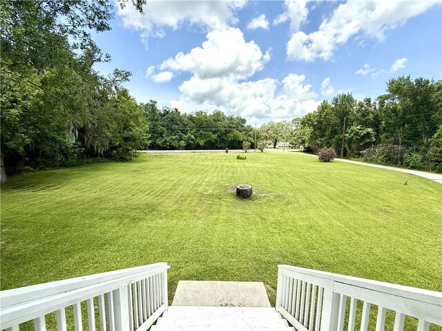 7282 Barataria Blvd, Marrero, LA 70072 - view of green lawn with view of wooded area