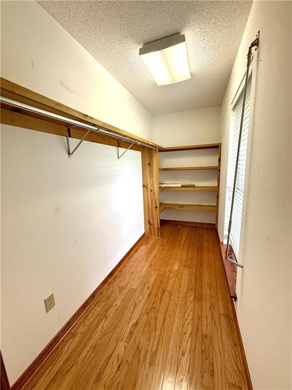 7282 Barataria Blvd, Marrero, LA 70072 - walk in closet with light wood finished floors