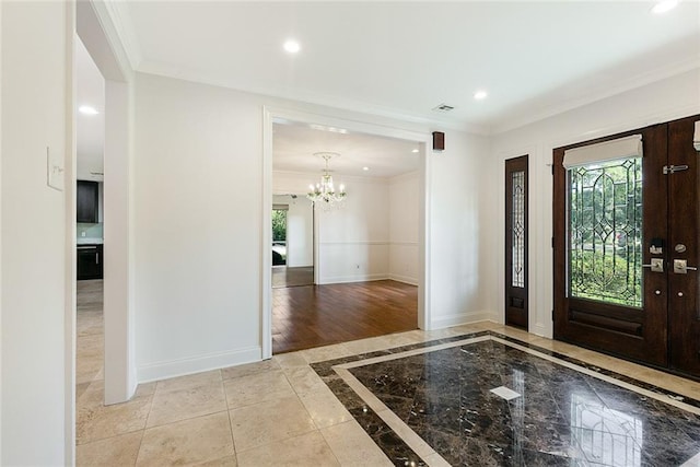 700 Crystal St, New Orleans, LA 70124 - foyer entrance with inlaid floor details, ornamental molding, a chandelier, and recessed lighting