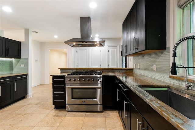 700 Crystal St, New Orleans, LA 70124 - kitchen featuring high end stove, ventilation hood, backsplash, dark cabinets, and recessed lighting