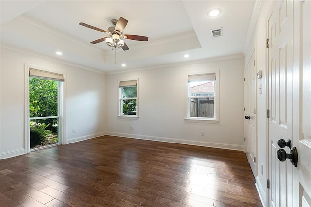700 Crystal St, New Orleans, LA 70124 - spare room featuring plenty of natural light, dark wood-type flooring, a tray ceiling, crown molding, and recessed lighting