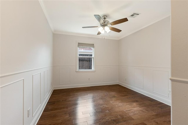 700 Crystal St, New Orleans, LA 70124 - unfurnished room with ceiling fan, wood finished floors, crown molding, a decorative wall, and wainscoting