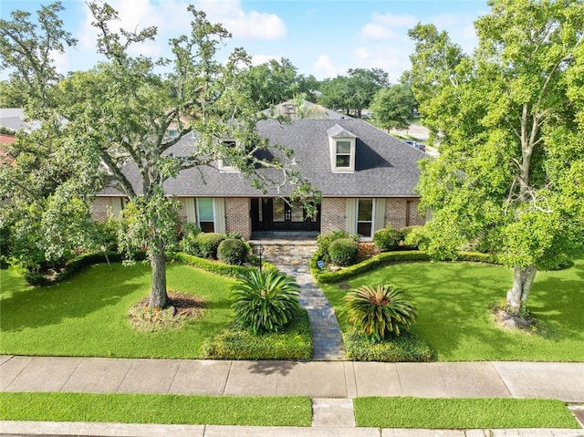 700 Crystal St, New Orleans, LA 70124 - cape cod-style house featuring brick siding, a front lawn, and roof with shingles