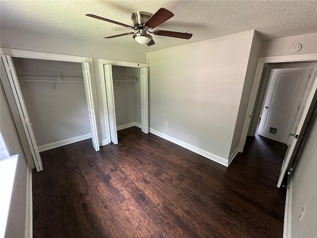 1505 Saint Ann Pl, Slidell, LA 70460 - unfurnished bedroom featuring multiple closets, wood finished floors, a textured ceiling, and ceiling fan