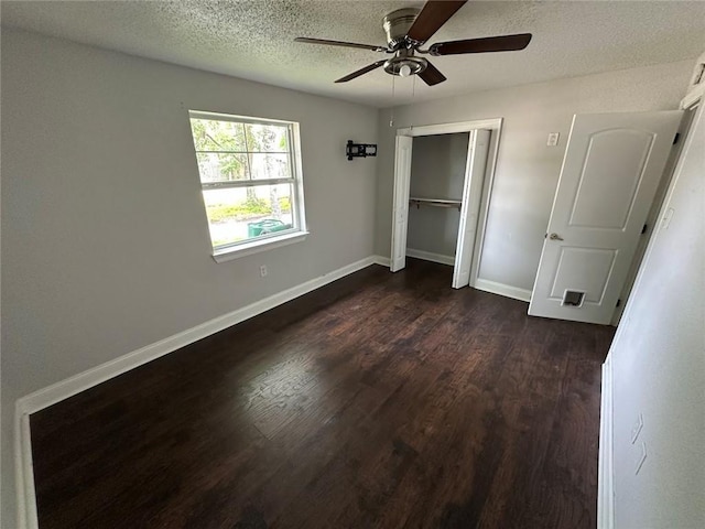 1505 Saint Ann Pl, Slidell, LA 70460 - unfurnished bedroom featuring dark wood-style flooring, a textured ceiling, a closet, and a ceiling fan