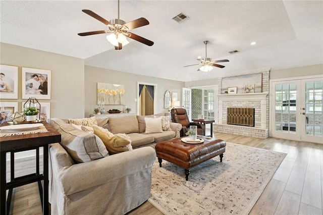33 Rosedown Dr, Destrehan, LA 70047 - living room with ceiling fan, vaulted ceiling, a textured ceiling, french doors, and light wood finished floors