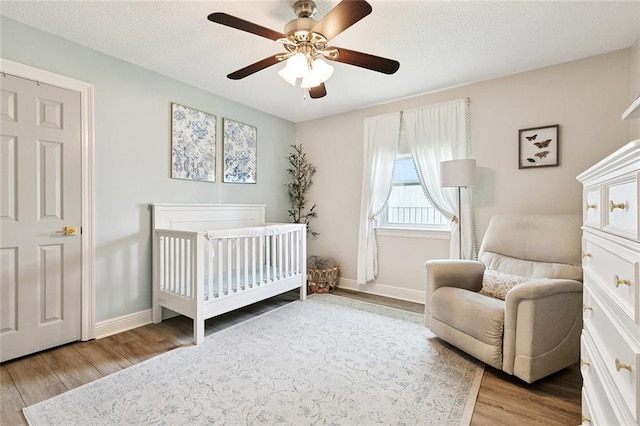 33 Rosedown Dr, Destrehan, LA 70047 - bedroom with wood finished floors, a nursery area, and ceiling fan