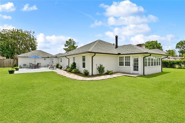 33 Rosedown Dr, Destrehan, LA 70047 - rear view of property featuring a patio area, brick siding, roof with shingles, and a chimney