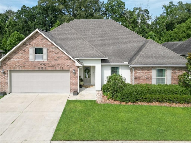 17509 Waterloo Dr, Baton Rouge, LA 70817 - view of front of property with a shingled roof, a front yard, concrete driveway, and brick siding