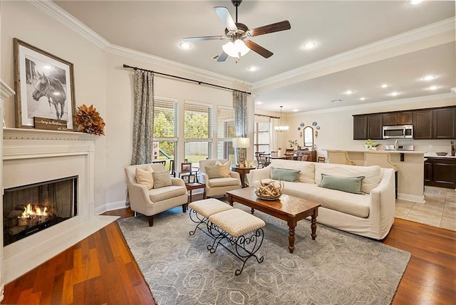 17509 Waterloo Dr, Baton Rouge, LA 70817 - living area featuring ceiling fan, ornamental molding, a fireplace with flush hearth, light wood finished floors, and recessed lighting
