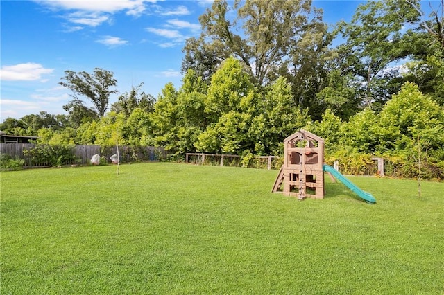 17509 Waterloo Dr, Baton Rouge, LA 70817 - fenced backyard featuring a playground and view of scattered trees