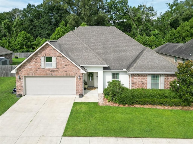 17509 Waterloo Dr, Baton Rouge, LA 70817 - view of front of house with roof with shingles, driveway, a garage, and brick siding