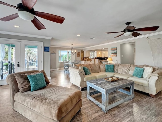 4230 Murano Rd, New Orleans, LA 70129 - living area with ornamental molding, light wood-type flooring, recessed lighting, ceiling fan, and a chandelier