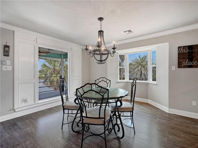 4230 Murano Rd, New Orleans, LA 70129 - dining area with crown molding, a chandelier, and dark wood-style flooring