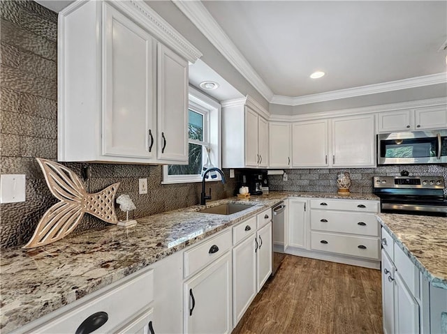 4230 Murano Rd, New Orleans, LA 70129 - kitchen with appliances with stainless steel finishes, white cabinetry, wood finished floors, light stone countertops, and crown molding