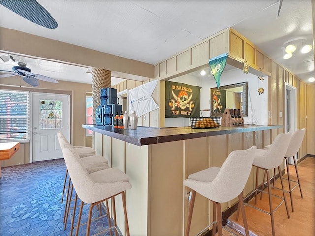4230 Murano Rd, New Orleans, LA 70129 - kitchen featuring dark countertops, a breakfast bar, and ceiling fan