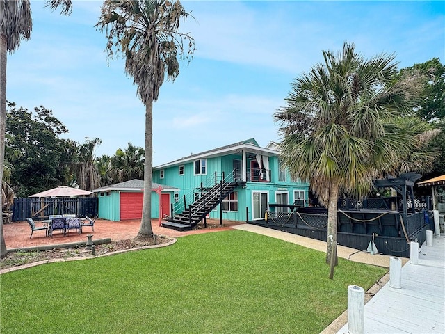 4230 Murano Rd, New Orleans, LA 70129 - view of front of house featuring stairs, a storage shed, and a patio area