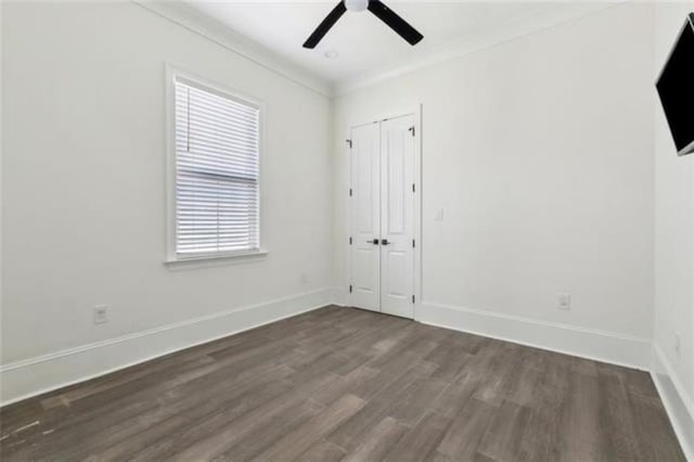 2342 Odin St, New Orleans, LA 70122 - unfurnished bedroom featuring dark wood finished floors, crown molding, a ceiling fan, and a closet