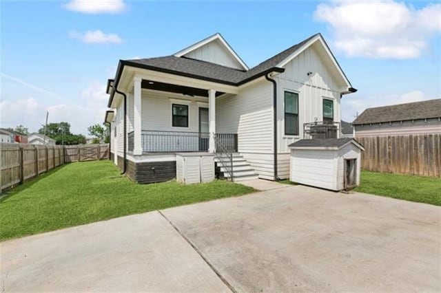 2342 Odin St, New Orleans, LA 70122 - view of front of home featuring covered porch, a shed, board and batten siding, and a fenced backyard