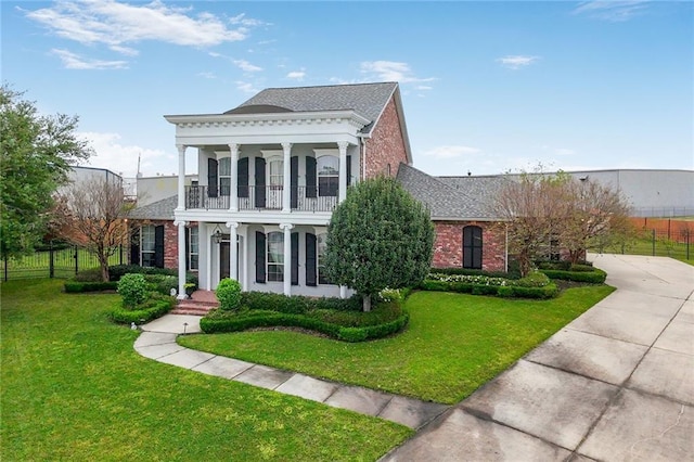 601 Ferriday Ct, Harahan, LA 70123 - neoclassical / greek revival house featuring a balcony, brick siding, a shingled roof, and covered porch