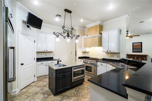 601 Ferriday Ct, Harahan, LA 70123 - kitchen featuring stainless steel appliances, crown molding, white cabinetry, pendant lighting, and a ceiling fan