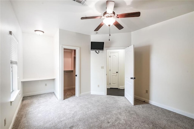 601 Ferriday Ct, Harahan, LA 70123 - unfurnished bedroom featuring carpet floors, a walk in closet, and a ceiling fan