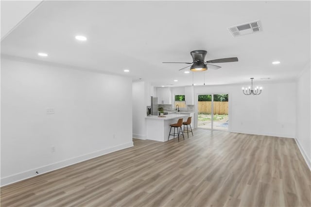 540 Ruth Dr, Westwego, LA 70094 - living room with ceiling fan, recessed lighting, a chandelier, and light wood finished floors