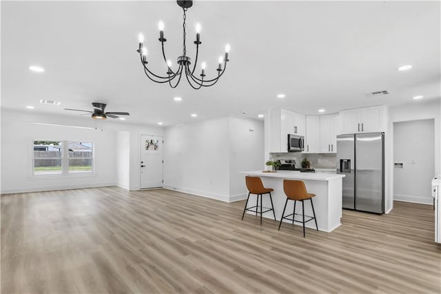 540 Ruth Dr, Westwego, LA 70094 - kitchen featuring stainless steel appliances, light countertops, recessed lighting, light wood-style flooring, and white cabinetry