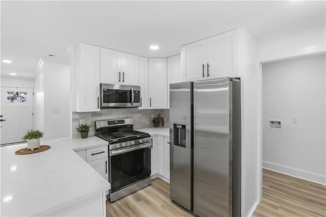540 Ruth Dr, Westwego, LA 70094 - kitchen with stainless steel appliances, light wood-type flooring, white cabinets, and recessed lighting